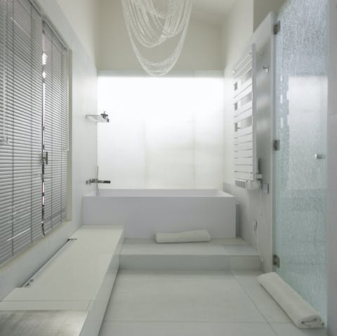 Take a relaxing soak in the all white bathroom