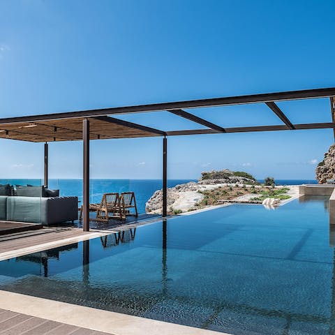 Swim laps in the long pool overlooking the sea