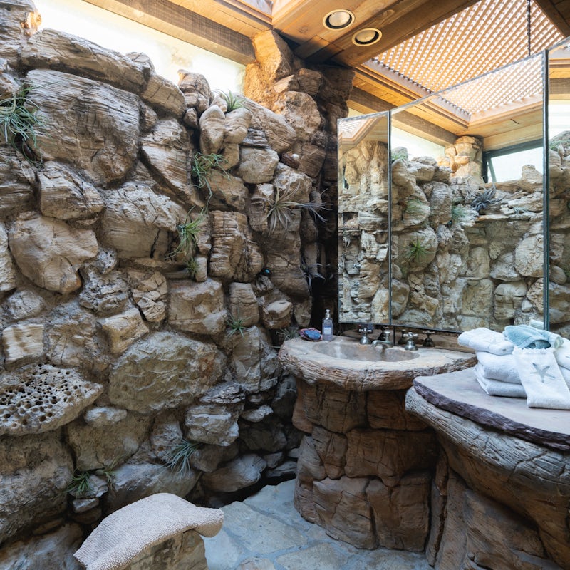 Wash off those sandy toes in the earthy, stone bathroom