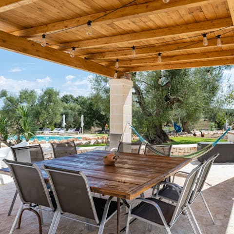 Cook in the outdoor kitchen and dine alfresco by the pool