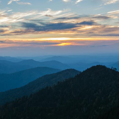 Catch the sunrise at Great Smoky Mountains National Park, just a thirty-minute drive away