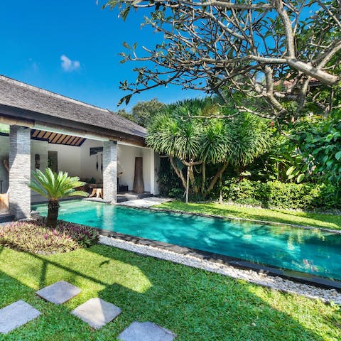 Relax in the private pool amid the lush green surroundings