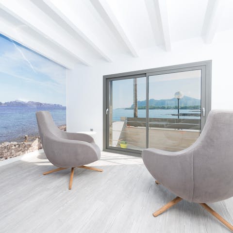 Relax in the velvet armchairs as you gaze out to Cap de Formentor