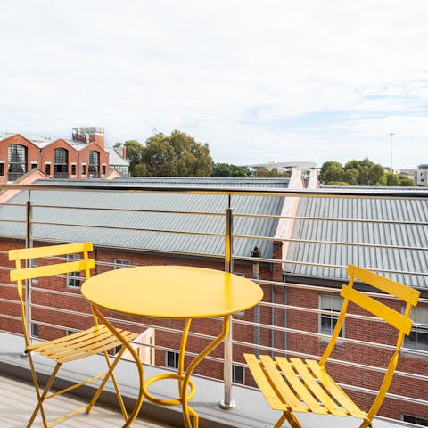 Enjoy a morning coffee out on your private balcony as the city wakes below