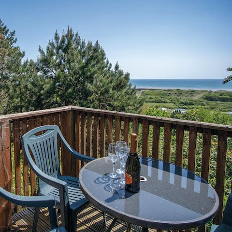 Sip a glass of bubbly and drink in the sea views from the balcony