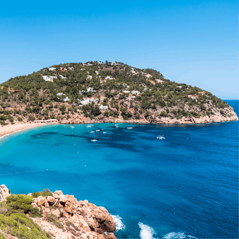 Spend the day in the turquoise surf of Cala Salada, only minutes away