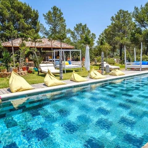 Claim your beanbag and lounge poolside with a cocktial