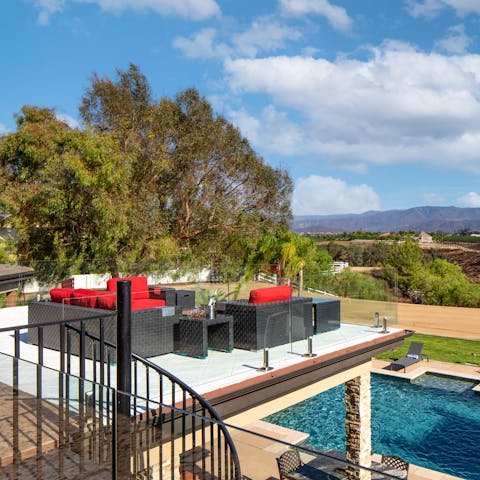 Admire the mountain views — or gaze down at the pool below —from the first floor balcony