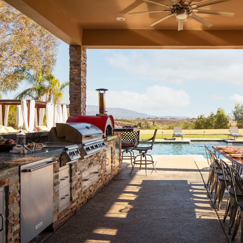 Host an unforgettable summer soiree in the astonishingly well-equipped outdoor kitchen