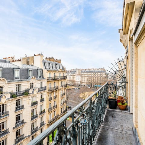Sip your coffee from the balcony overlooking the Haussmann buildings