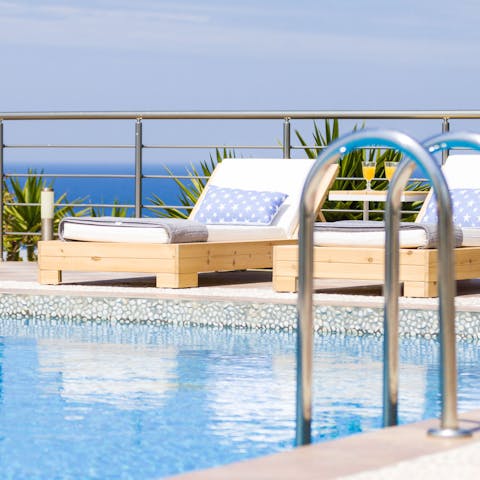 Catch some rays on the lounge chairs after a swim in the infinity pool