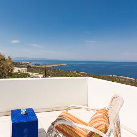 Admire the Mediterranean views from the balcony, a glass of Ouzo in hand 