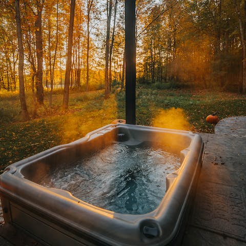Sink into the hot tub, watching the sunset through the forest trees