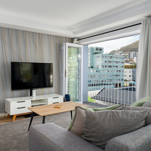 Relax in the bright living area, with the balcony doors thrown open