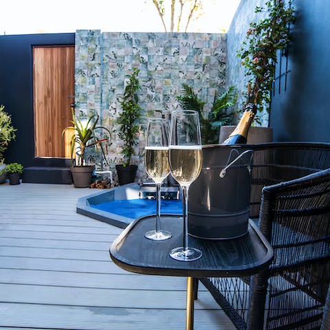 Enjoy a glass of bubbly in your wood-fired hot tub