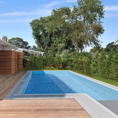 Plunge into the pristine swimming pool in the backyard