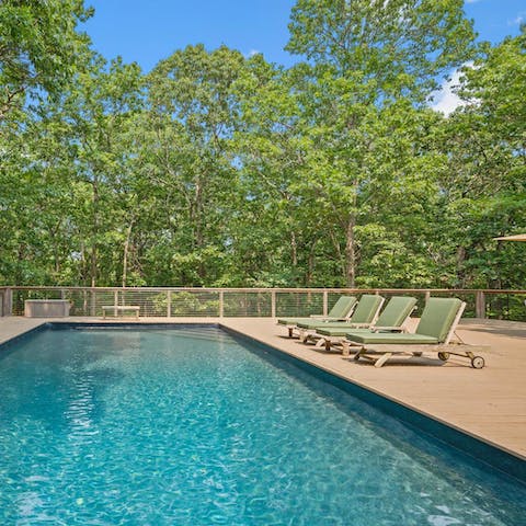 Relax by the glistening heated saltwater pool with the stunning trees around you 