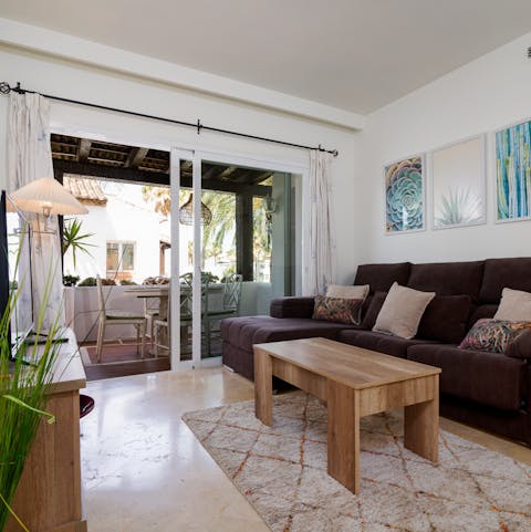 Open up the glass sliding doors to blend the terrace with the living room