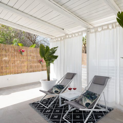 Stretch out on the loungers with your new read, under the shade of the pergola