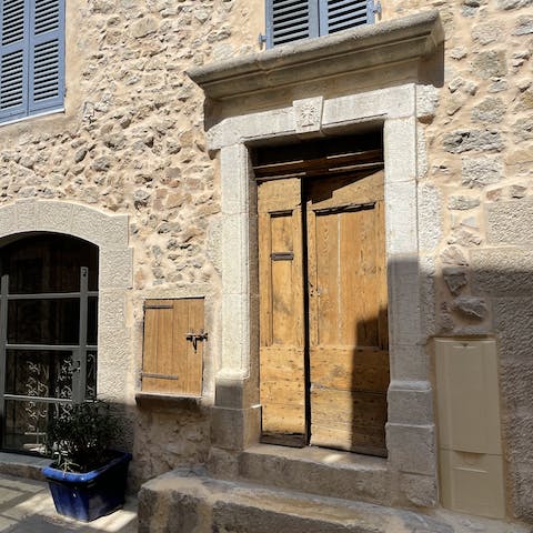 Admire the traditional wooden door and blue shutters of the exterior