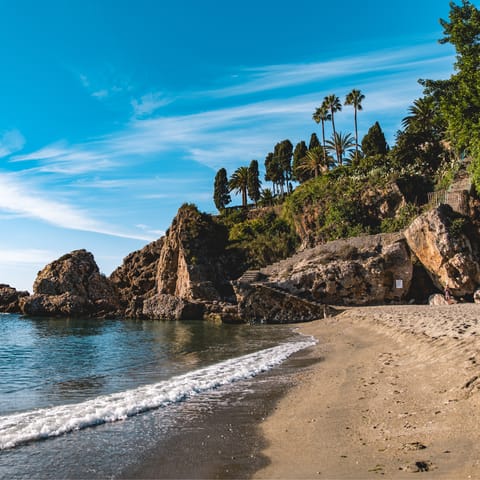 Feel the sand beneath your toes on a beach in Nerja