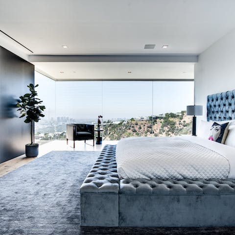 See the city stretch before you from the wall of glass in the master bedroom