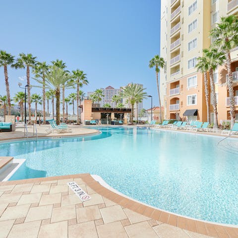 Swim across the shared outdoor pool to cool off from the Florida sun