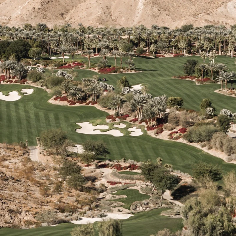 Play a round of golf beside the mountains