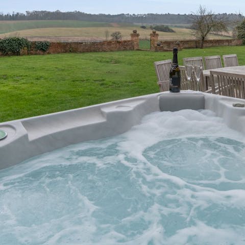 Relax and unwind in the huge outdoor hot tub, with stunning country views around you 