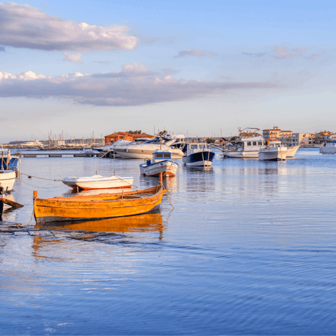 Take walks along the charming harbour of Marzamemi, a six-minute-drive away 
