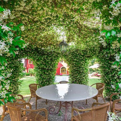 Sip an aperitif in the flower-adorned gazebo