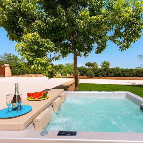 Take in the views of the lush garden from the Jacuzzi