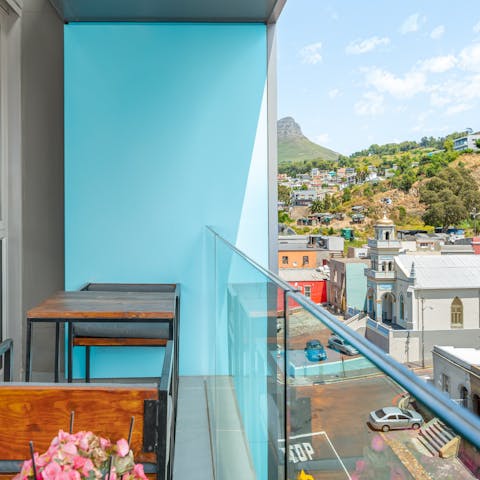 Savour a fresh morning coffee on your balcony, overlooking the hills dotted with houses