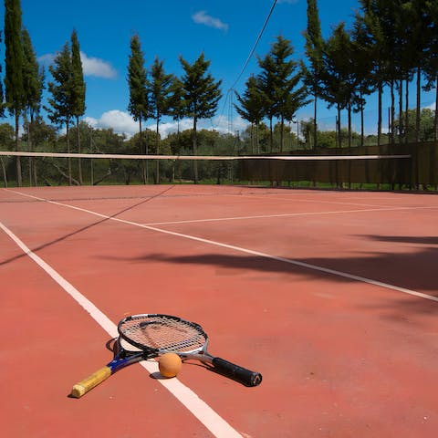 Challenge your friends to a game of tennis on the private court