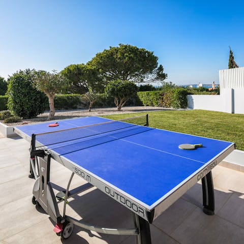 Enjoy a game of table tennis with loved ones as the sun warms your skin
