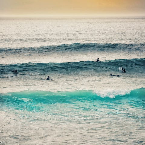 Learn to surf to beginner-friendly waves at Polzeath Beach, a five-minute drive away