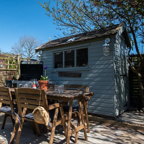 Fire up the barbecue on long summer nights – the outside lighting will keep the night flowing