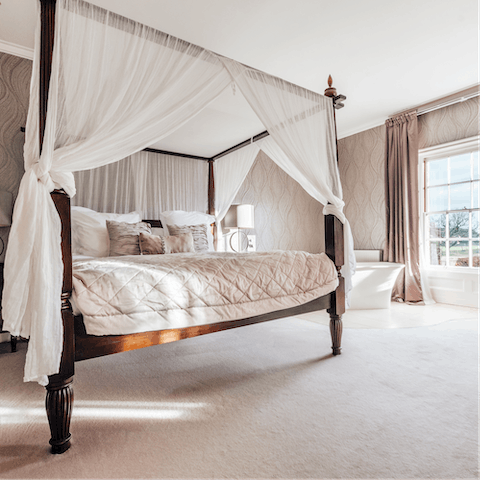 Sleep like royalty in the four-poster bed in the master bedroom