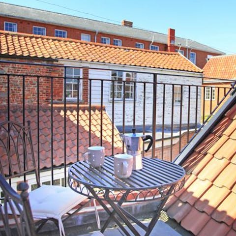 Start the day with freshly brewed coffee up among the rooftops