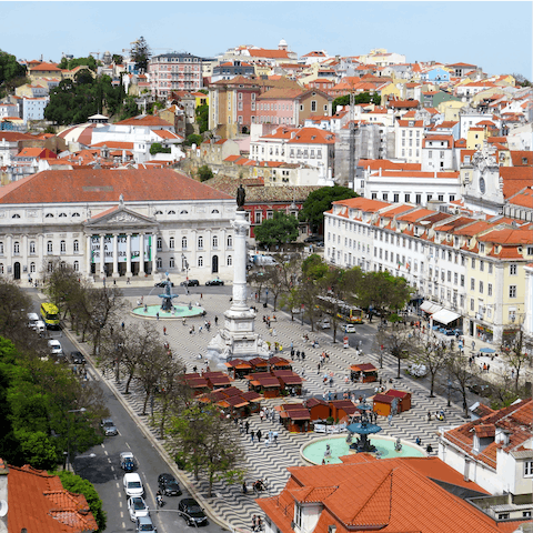 Visit Rossio Square, a fifteen-minute metro ride away