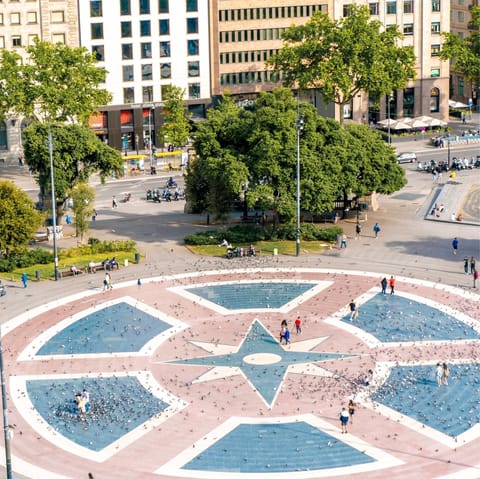 Sit and people-watch at Plaça de Catalunya, a quarter of an hour's walk from the home
