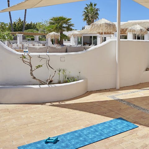 Stretch out on your yoga mat in the sun or underneath the shaded canopy