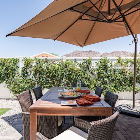 Share an alfresco meal at the outdoor dining table, admiring the mountain views