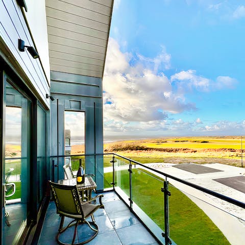 Take in the scenes of the eighteenth hole and sparkling sea on the balcony