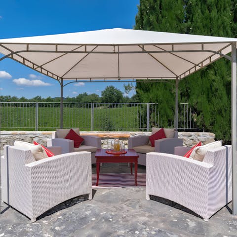 Enjoy afternoon drinks on the terrace in the shade of the gazebo 
