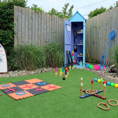 Let the kids have fun in the back garden with the home's toys
