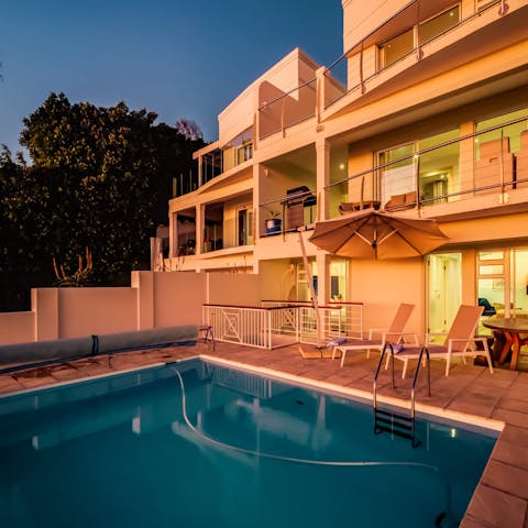 Swim lengths in the pool under the glow of the sun