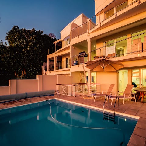 Swim lengths in the pool under the glow of the sun