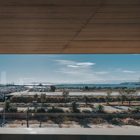 Admire the views over the Aegean Sea from the private balcony