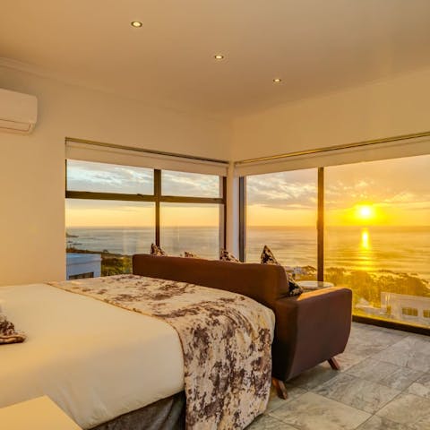 Sink into your soft sheets with panoramic sunset views